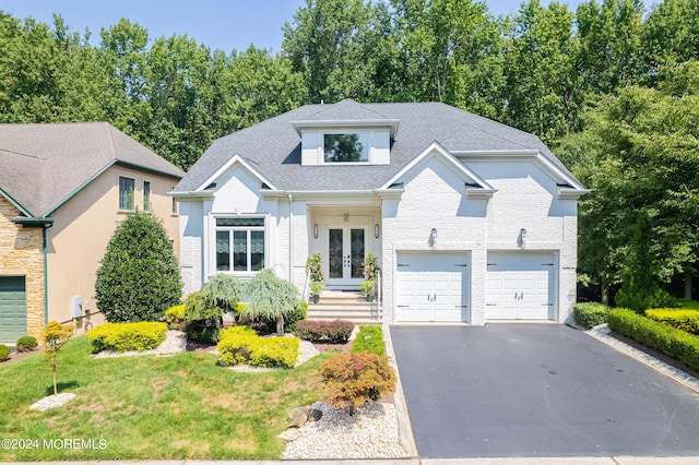 view of front of property with french doors and a garage