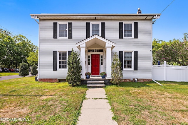 colonial-style house with a front yard