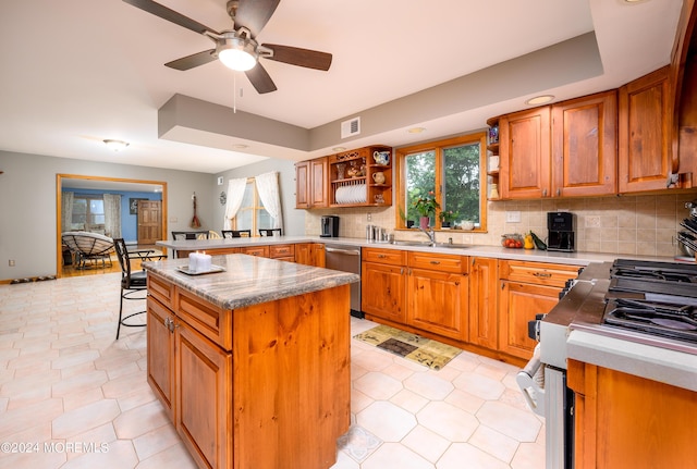 kitchen featuring stainless steel appliances, a peninsula, brown cabinets, open shelves, and tasteful backsplash