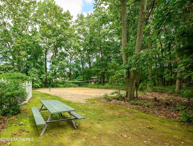 view of property's community featuring a lawn and volleyball court