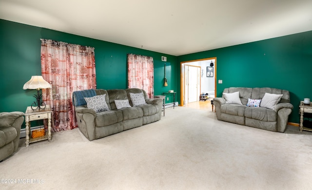 living area featuring a baseboard heating unit and carpet flooring