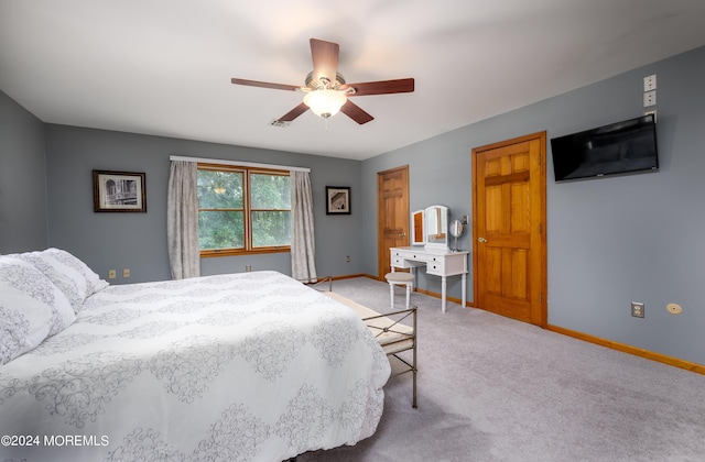 carpeted bedroom featuring ceiling fan and baseboards