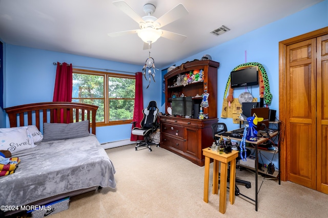 bedroom featuring a baseboard heating unit, carpet, visible vents, and a ceiling fan