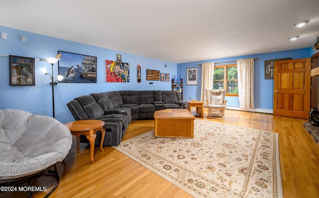 living room with light wood-type flooring, visible vents, and a baseboard radiator