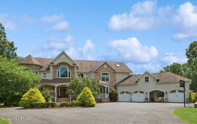 view of front of home featuring covered porch and a garage