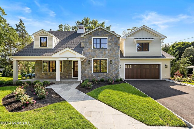 view of front of property with a garage and a front yard