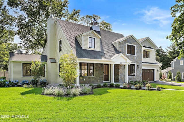 cape cod-style house featuring a garage and a front lawn