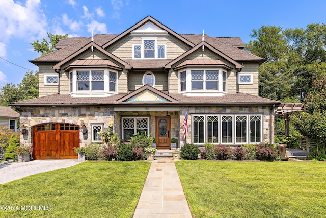 view of front of home with a garage and a front yard