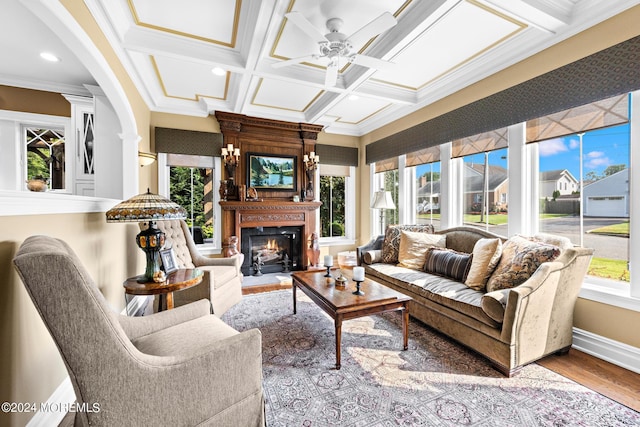 sunroom / solarium with ceiling fan, coffered ceiling, and plenty of natural light