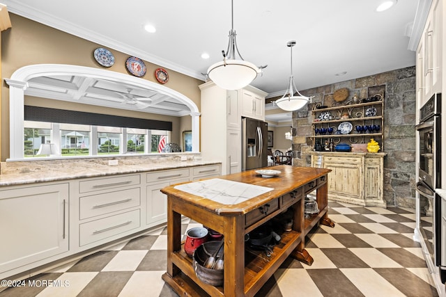 kitchen featuring appliances with stainless steel finishes, light stone counters, coffered ceiling, light tile patterned floors, and pendant lighting