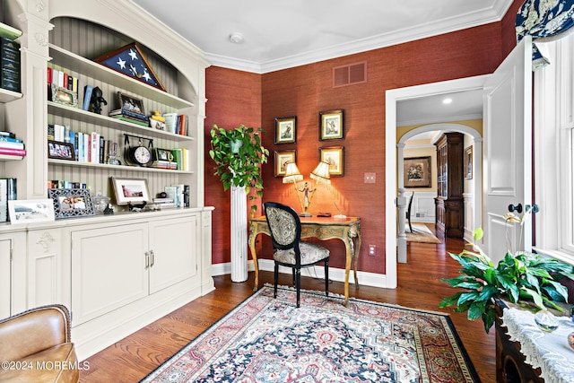 sitting room with decorative columns, dark hardwood / wood-style floors, and ornamental molding