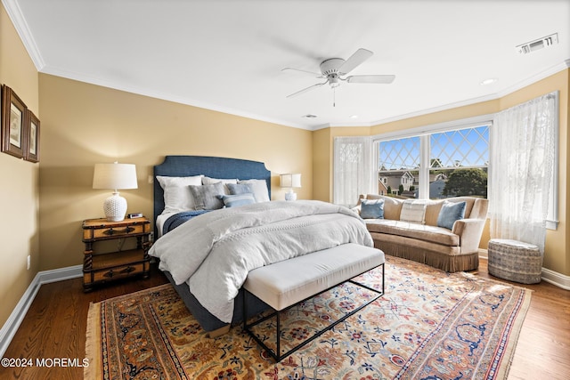 bedroom featuring ceiling fan, dark hardwood / wood-style floors, and ornamental molding