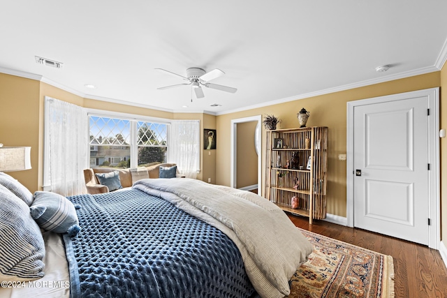 bedroom featuring ceiling fan, dark hardwood / wood-style floors, and ornamental molding