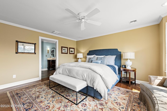 bedroom with dark hardwood / wood-style flooring, connected bathroom, crown molding, and ceiling fan