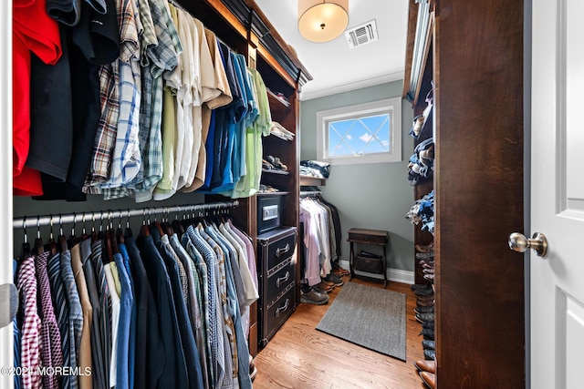 spacious closet with light hardwood / wood-style floors