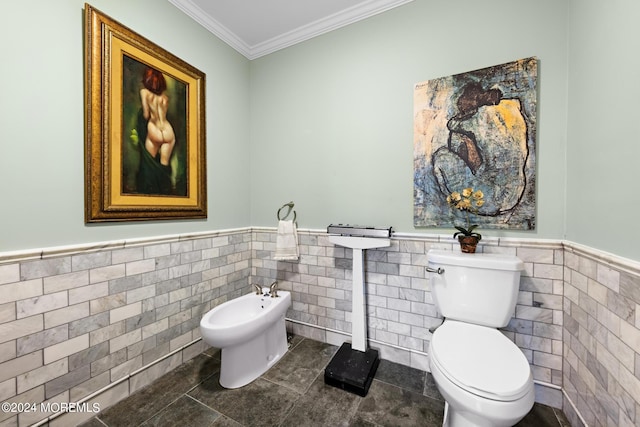 bathroom featuring a bidet, toilet, tile patterned floors, and tile walls