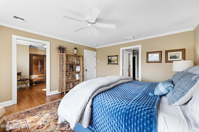 bedroom featuring hardwood / wood-style flooring, crown molding, and ceiling fan