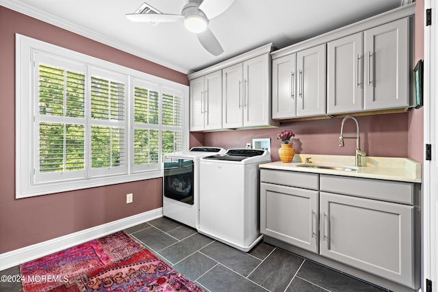 laundry area featuring sink, dark tile patterned flooring, cabinets, washer and dryer, and ceiling fan