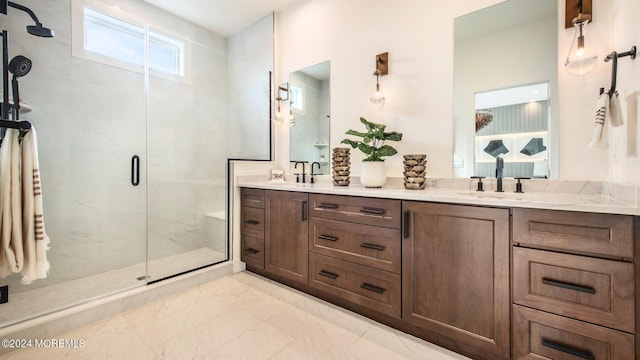 bathroom with an enclosed shower, dual vanity, and tile patterned floors