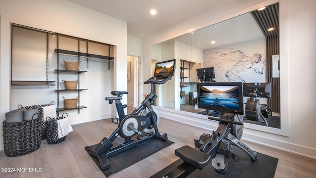 workout area with hardwood / wood-style flooring