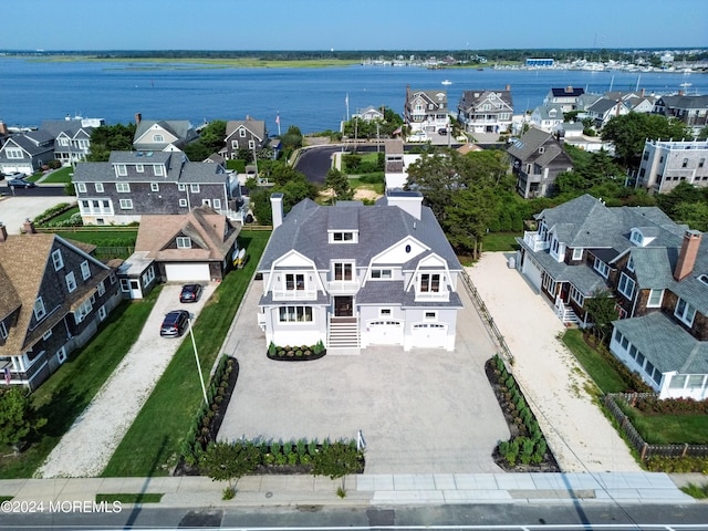 drone / aerial view featuring a residential view and a water view