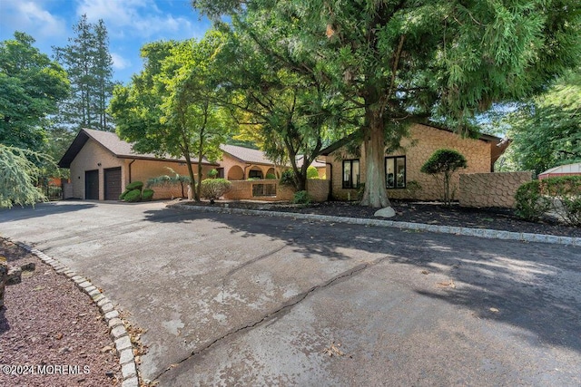 view of front of house with a garage and aphalt driveway
