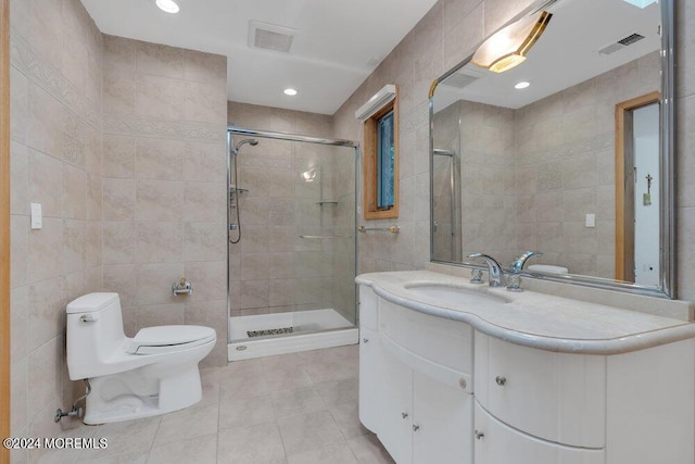 full bathroom featuring tile patterned flooring, toilet, tile walls, visible vents, and a stall shower