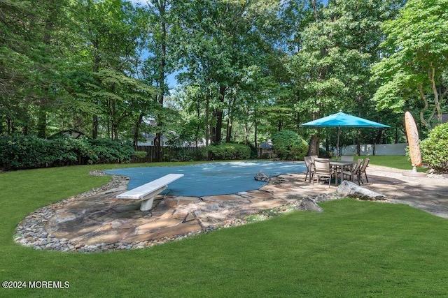 view of pool featuring a patio, a fenced backyard, and a yard