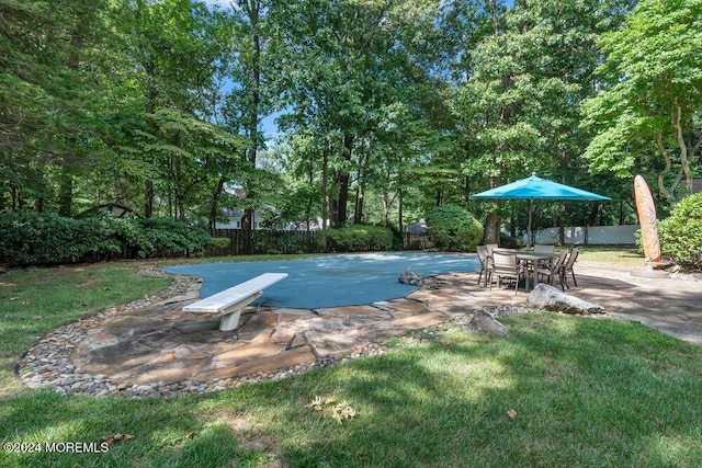 view of pool with a lawn, a fenced backyard, and a patio area