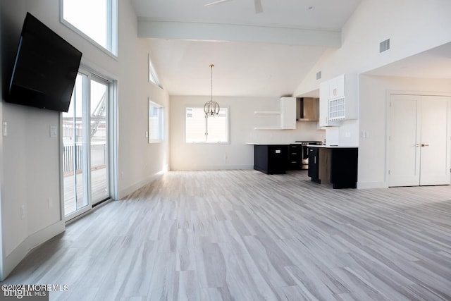 interior space with high vaulted ceiling, light hardwood / wood-style flooring, and a healthy amount of sunlight