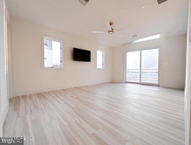 unfurnished living room featuring ceiling fan and light hardwood / wood-style flooring