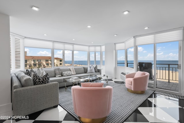 living room featuring a wealth of natural light and a water view