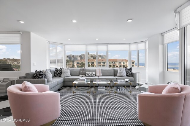 living room featuring plenty of natural light and a wall of windows