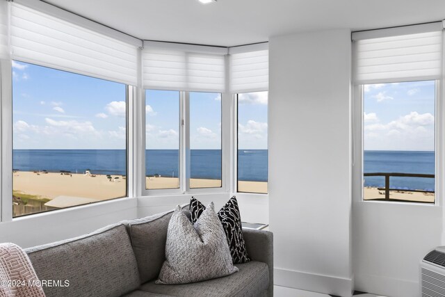 living room featuring a view of the beach and a water view