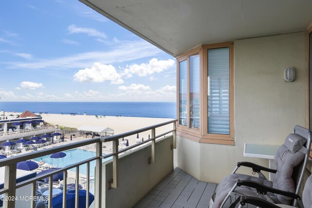 balcony with a view of the beach and a water view