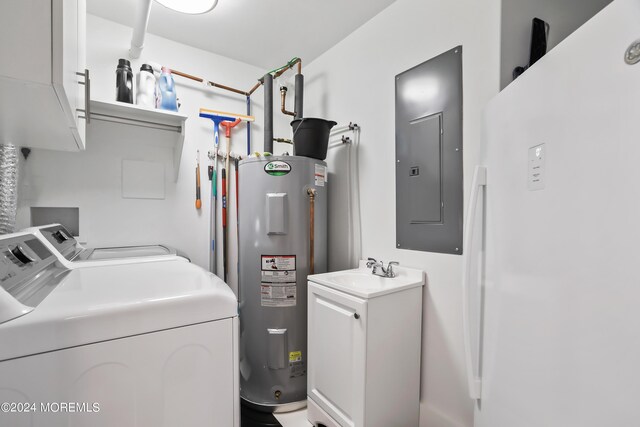 laundry area with washer and clothes dryer, electric water heater, cabinets, and electric panel