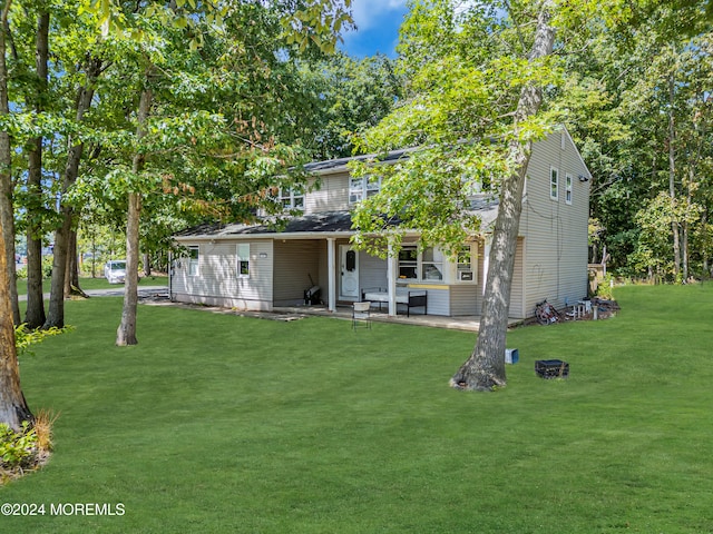 back of house featuring a patio and a yard