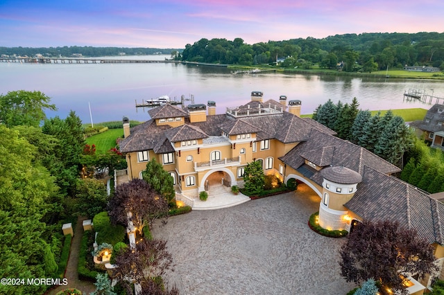 aerial view at dusk with a water view