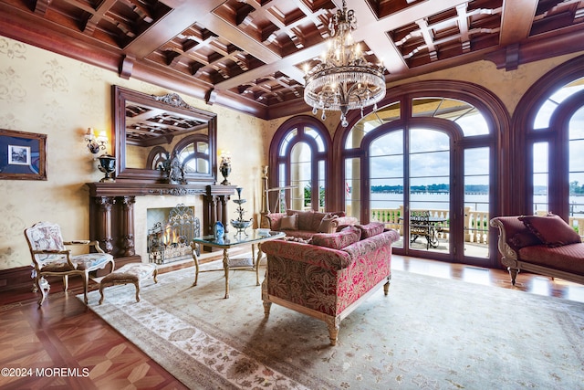 living room featuring an inviting chandelier, coffered ceiling, beamed ceiling, a water view, and parquet flooring