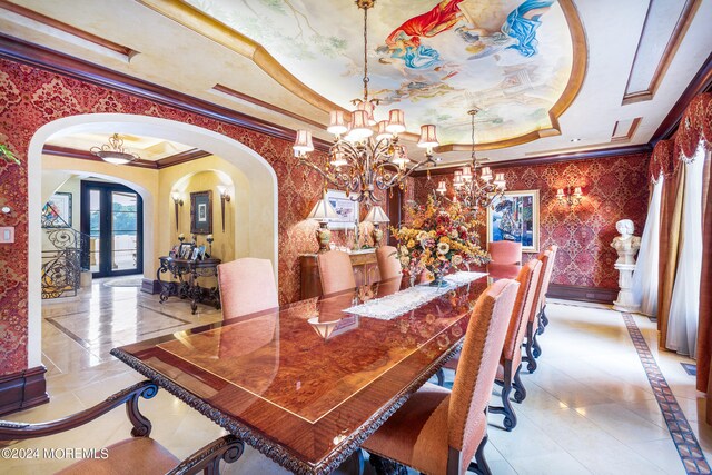 dining space featuring ornamental molding, a raised ceiling, light tile patterned floors, and a chandelier