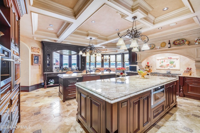 kitchen featuring decorative backsplash, coffered ceiling, light stone counters, stainless steel oven, and a center island