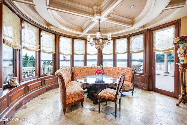 interior space with a wealth of natural light, coffered ceiling, a chandelier, and ornamental molding