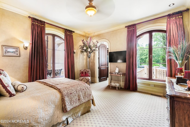 carpeted bedroom with ceiling fan, access to outside, and crown molding