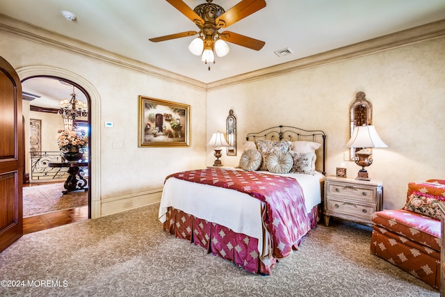 bedroom with crown molding and ceiling fan with notable chandelier