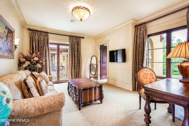 carpeted living room with crown molding and a healthy amount of sunlight