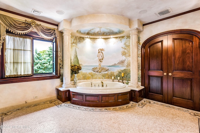 bathroom featuring ornate columns, a washtub, and ornamental molding