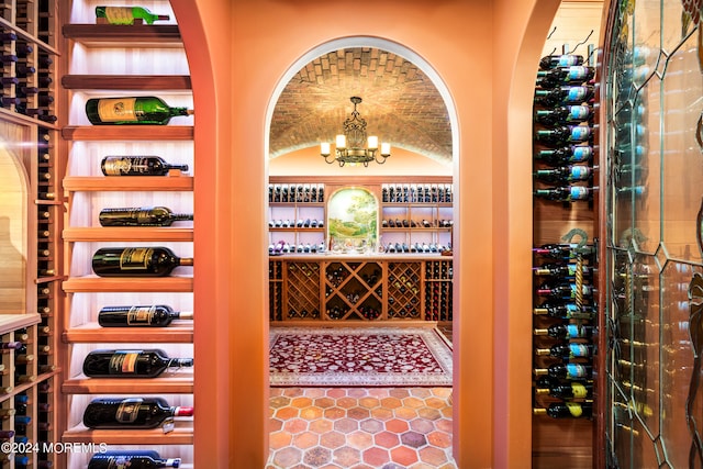 wine area featuring an inviting chandelier and tile patterned floors