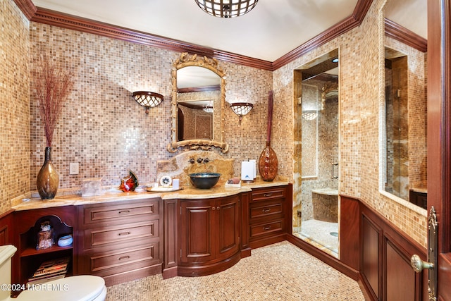 bathroom with decorative backsplash, a shower with door, toilet, vanity, and tile walls