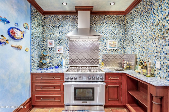 kitchen featuring backsplash, high end range, light tile patterned flooring, and wall chimney range hood