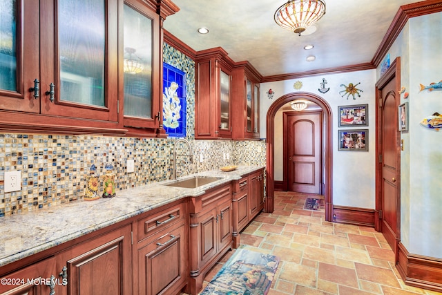 kitchen with sink, light stone counters, backsplash, and light tile patterned flooring